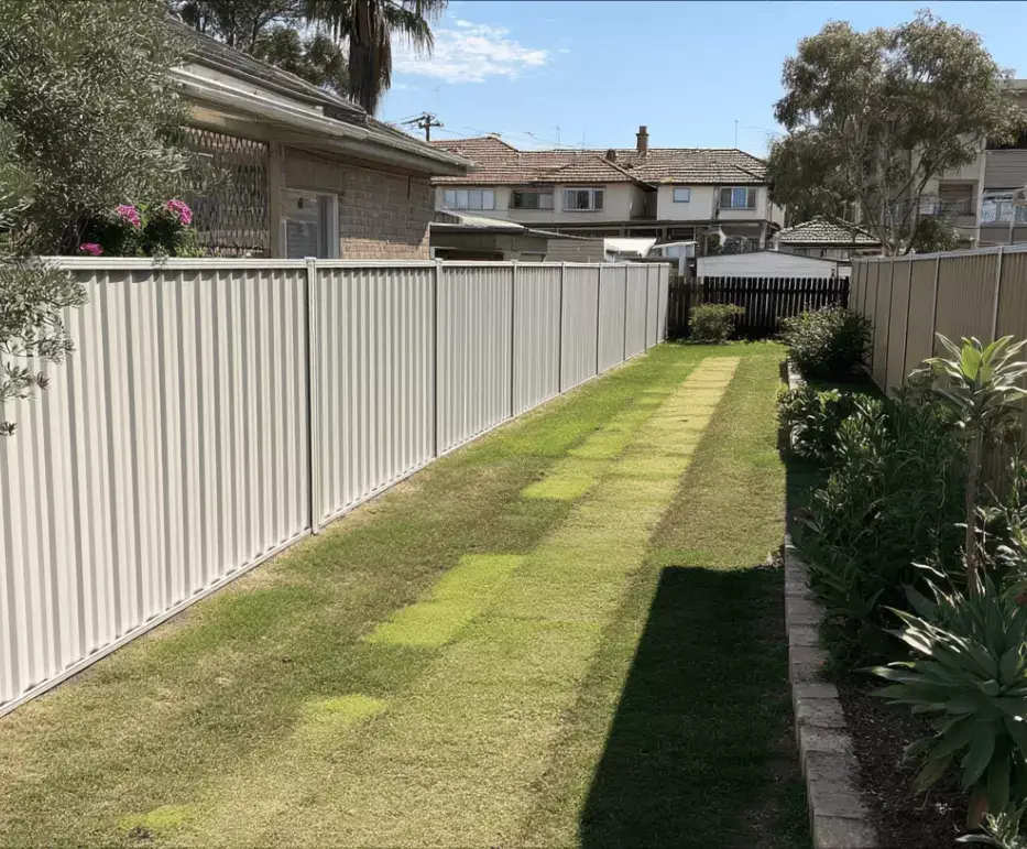 Lawn in Casula with white Colorbond fence
